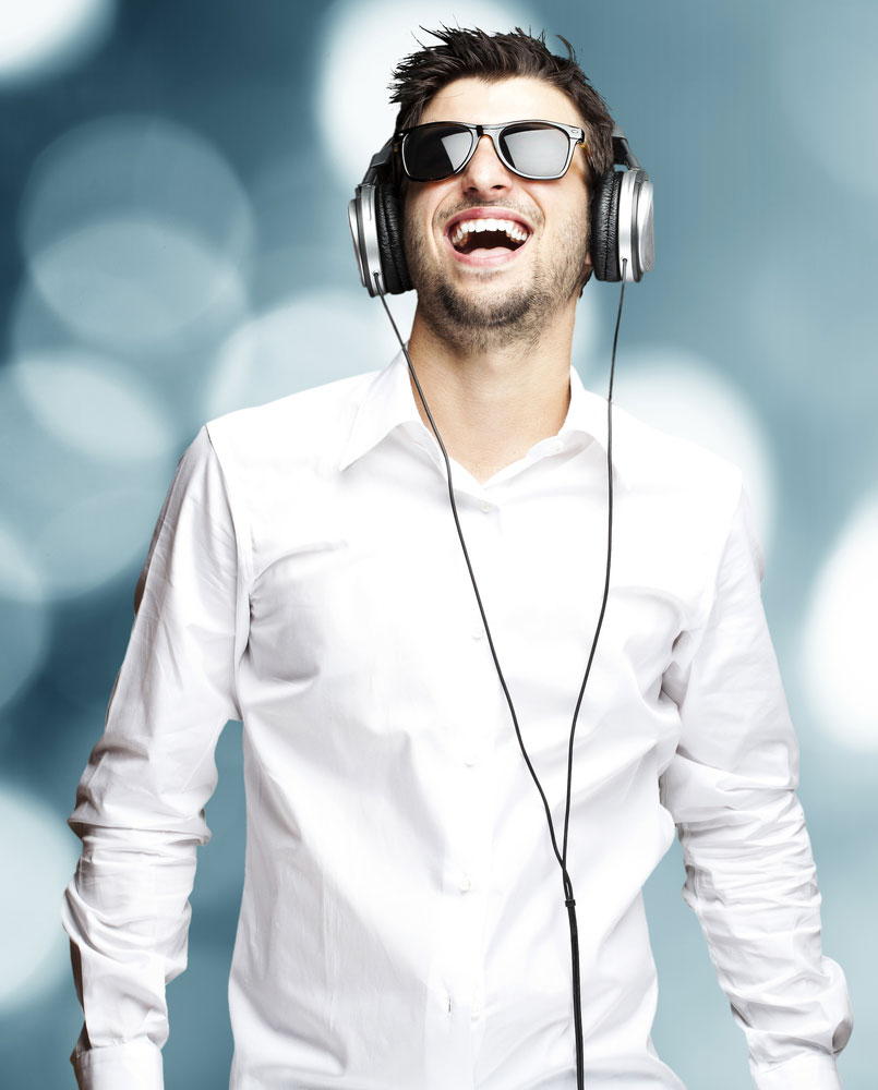 photo of smiling blind man with headphones on